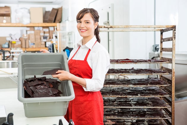 Beautiful woman with beef Jerky baking rack and container Beautiful woman with beef Jerky baking rack and container